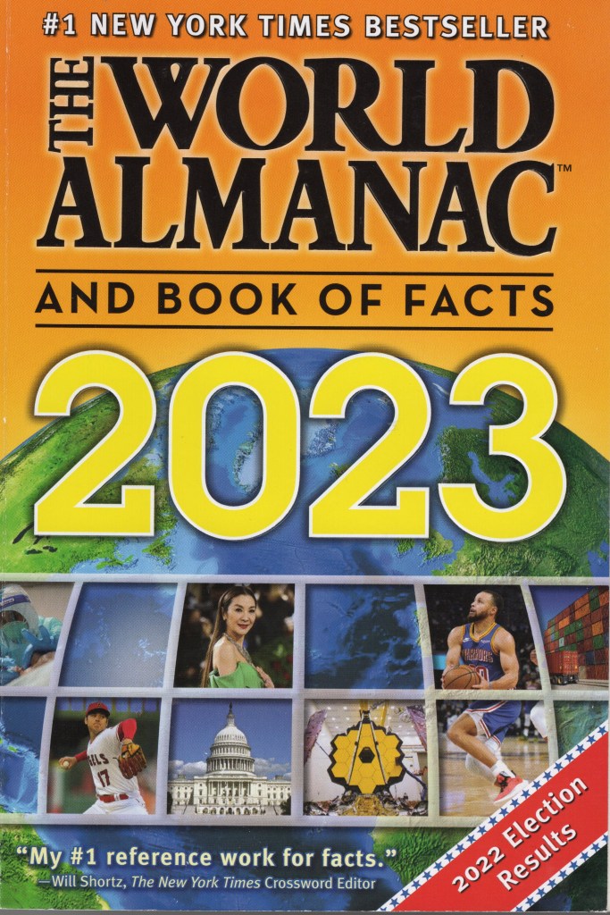 The colorful front page of The World Almanac and Book of Facts 2023. It features photographs of events in 2023 as well as a picture of the northern hemisphere of Earth.