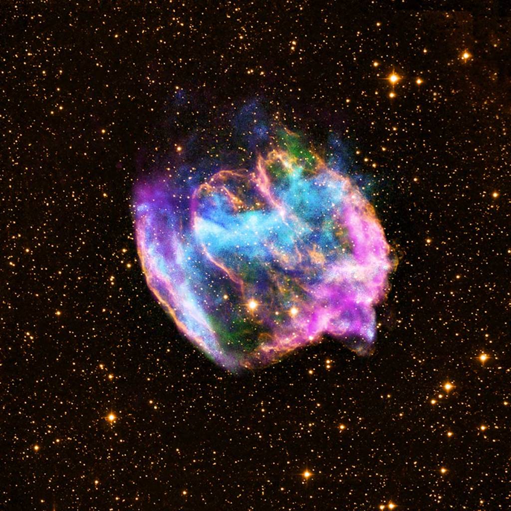 A colorful, nebula, a remnant from a supernova explosion on the background of a black sky full of stars.