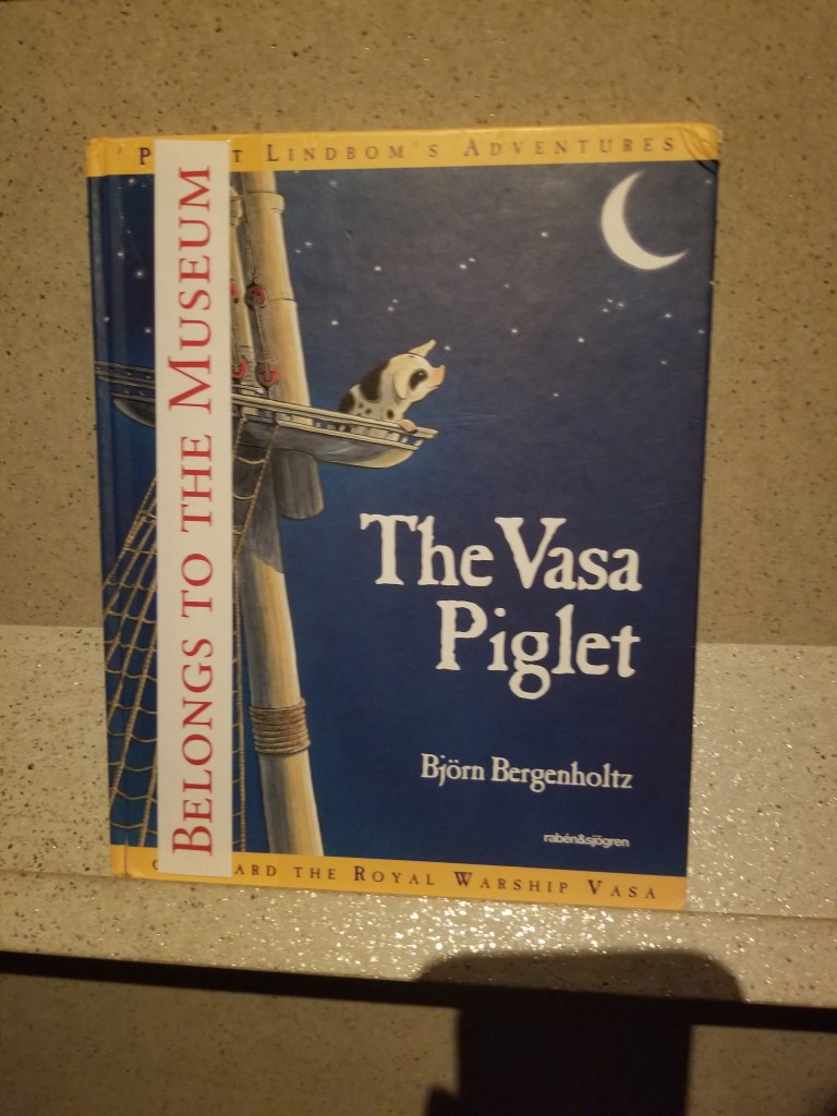 The front cover features a black and white pig sitting in the platform at the top of the mast.