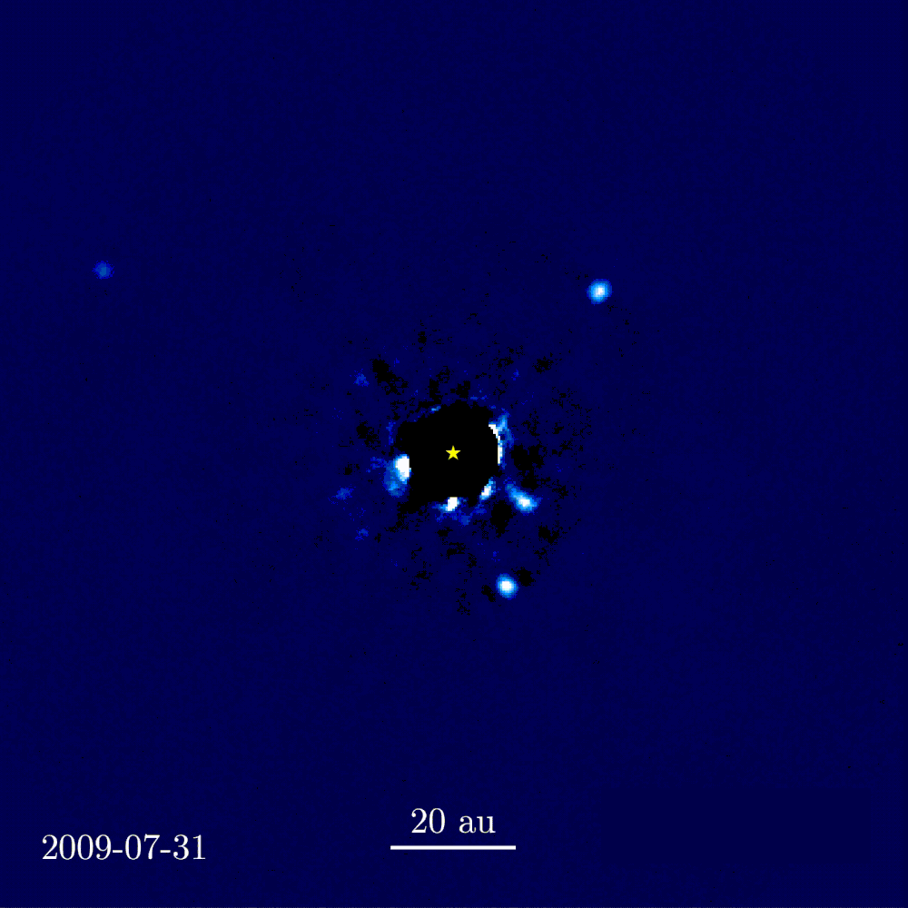 Star surrounded by four specks that are slowly moving around the star as movie plays | The Strange Worlds of Exoplanets