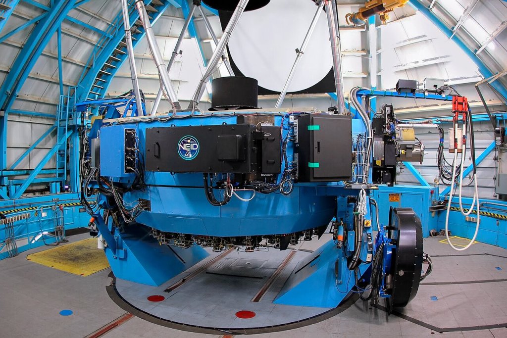 The blue NEID port adapter used for measuring the weight of exoplanets and more.