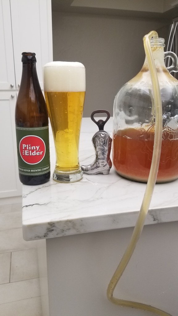 Carboy with siphoning tubing on the right. Pliny the Elder bottle and beer glass on the left | Measuring Alcohol by Volume in Home Brews
