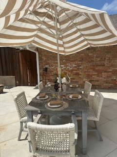A table set for five with a large parasol | The Great Sun and Moon Spectacle