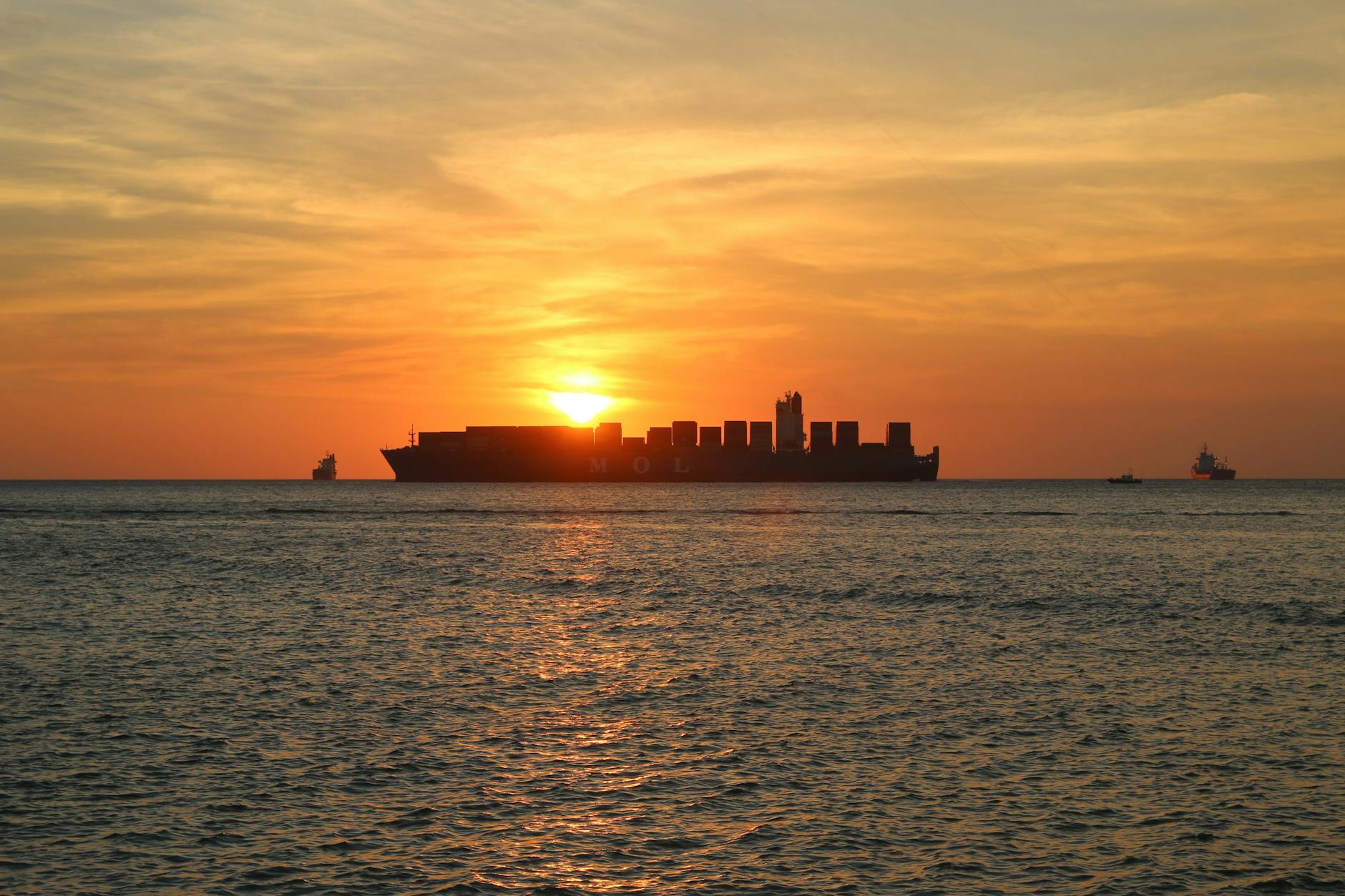 Cargo ship at sunset. Emissions from the transport of produce is not the main factor for emissions.