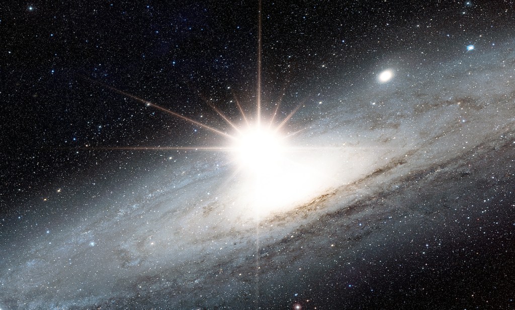 A picture of the Andromeda Galaxy with a bright white light near its center. The bright light is almost outshining the entire galaxy | Alien Civilizations and the Fermi Paradox