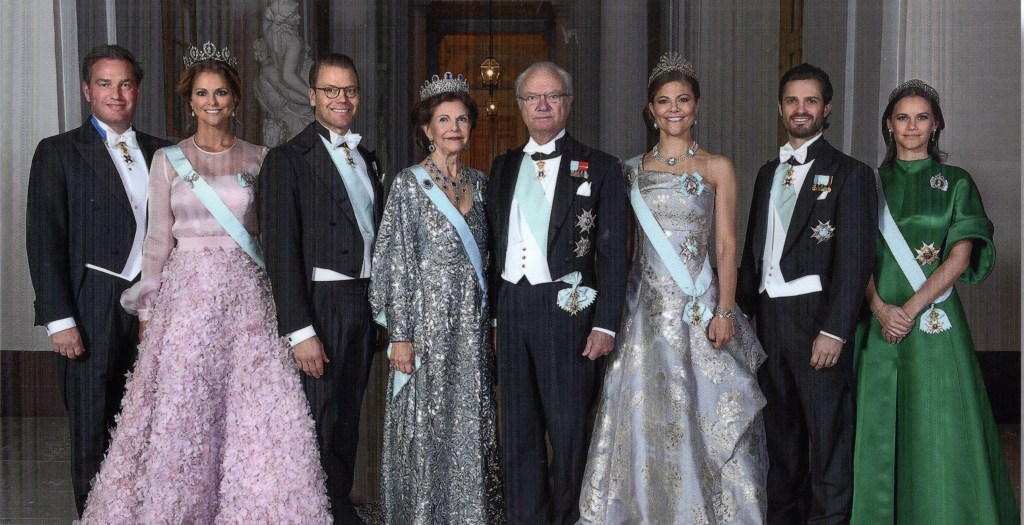 This is a photo of a well-dressed 8-member royal family.
