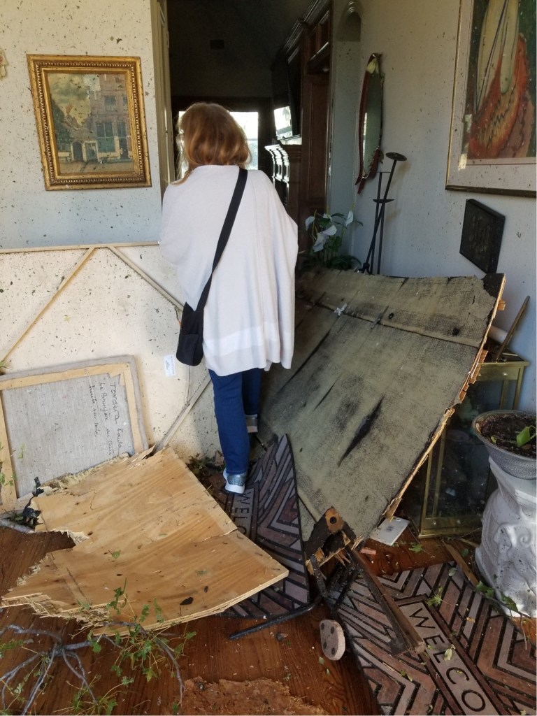 My wife Claudia is walking among the debris in my in-laws house.