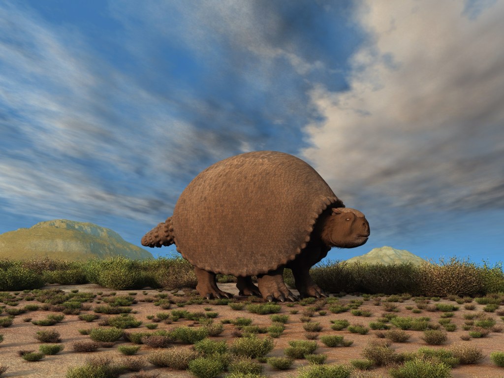 A Glyptodon walking across an empty prairie.