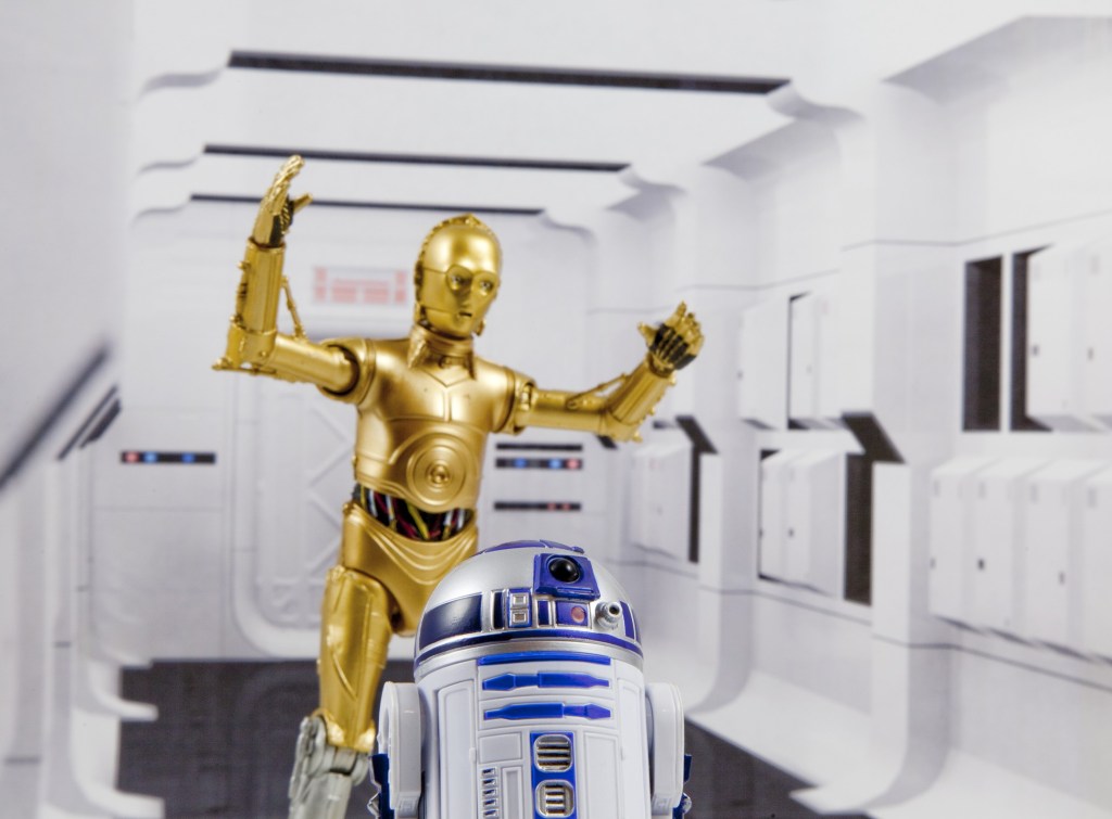 The photo shows a scene from Star Wars. C-3PO and R2-D2. C-3PO has a silver leg.