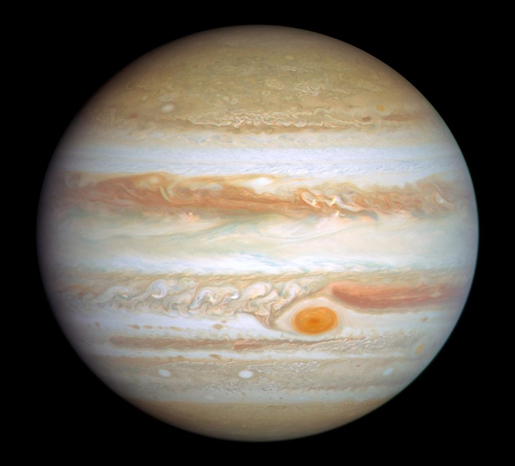 A colorful photo of Jupiter (orange and white) including the Great Red Spot.