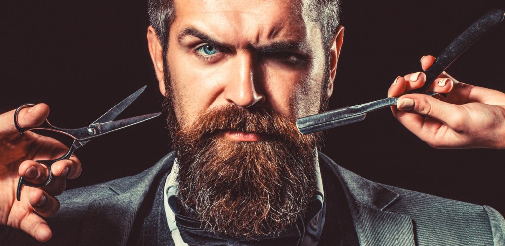 Bearded client visiting barber shop. Barber scissors and straight razor, barber shop, suit. Vintage barber shop, shaving. Portrait bearded man. Mustache men. Brutal guy, scissors, straight razor.