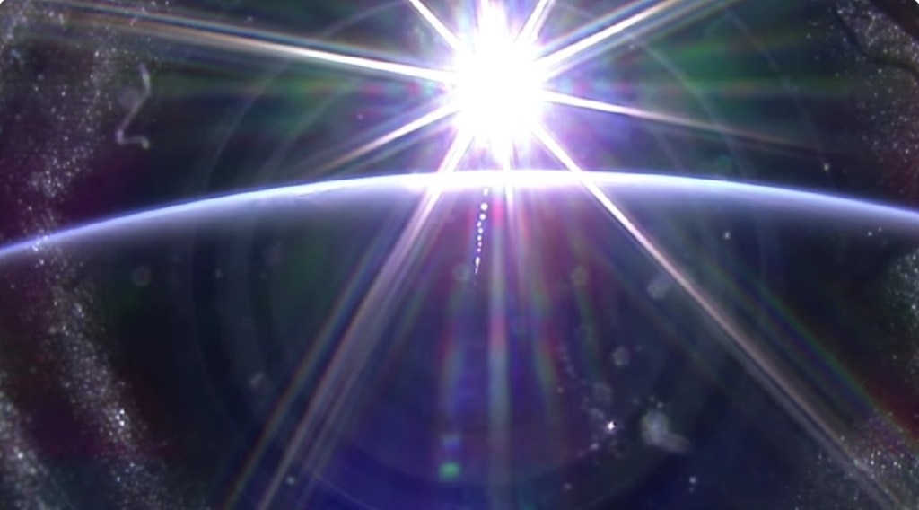 A bright white sun is setting over Earth