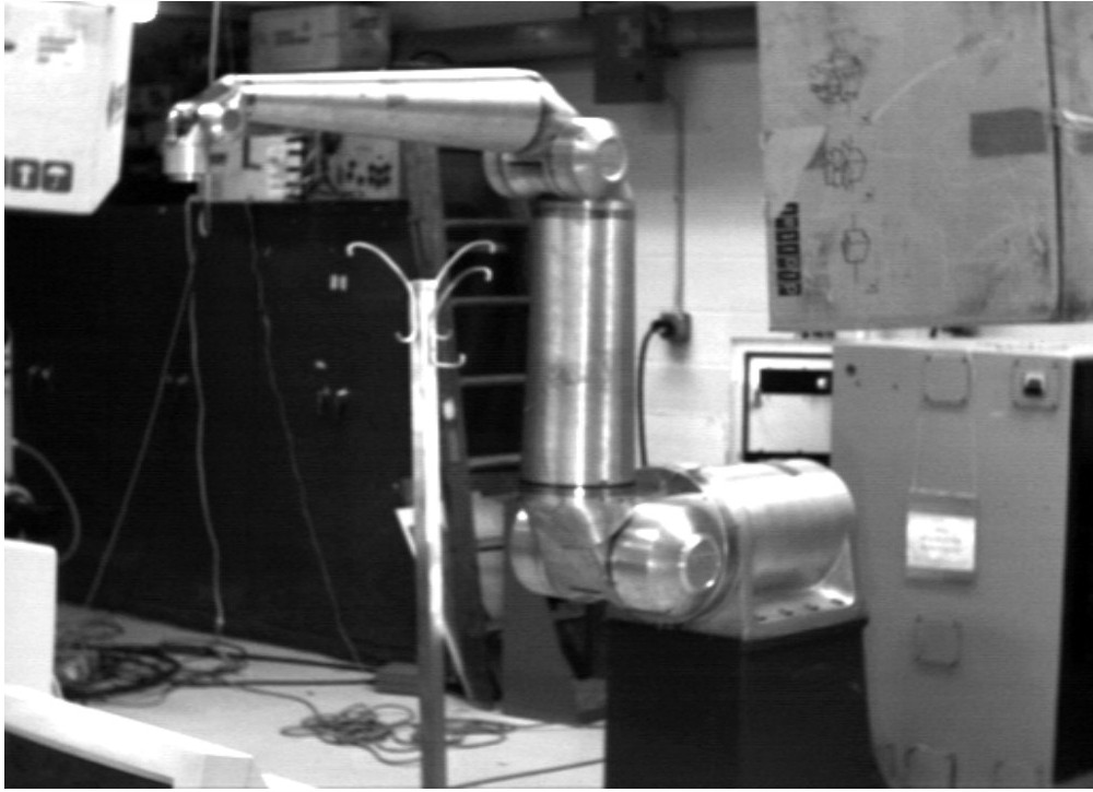 A picture of a large silver colored industrial robot.
