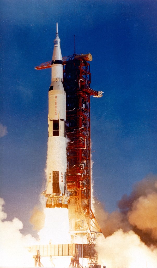 Smoke and fire surrounding the Saturn V launch.